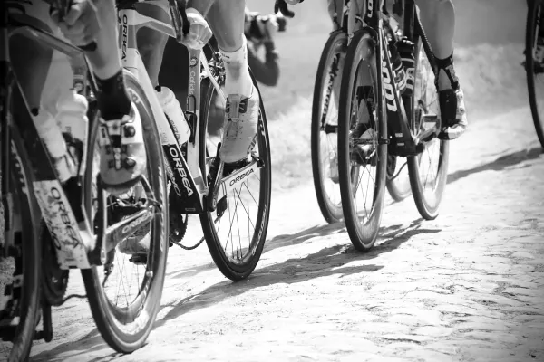 grayscale photo of people racing bikes